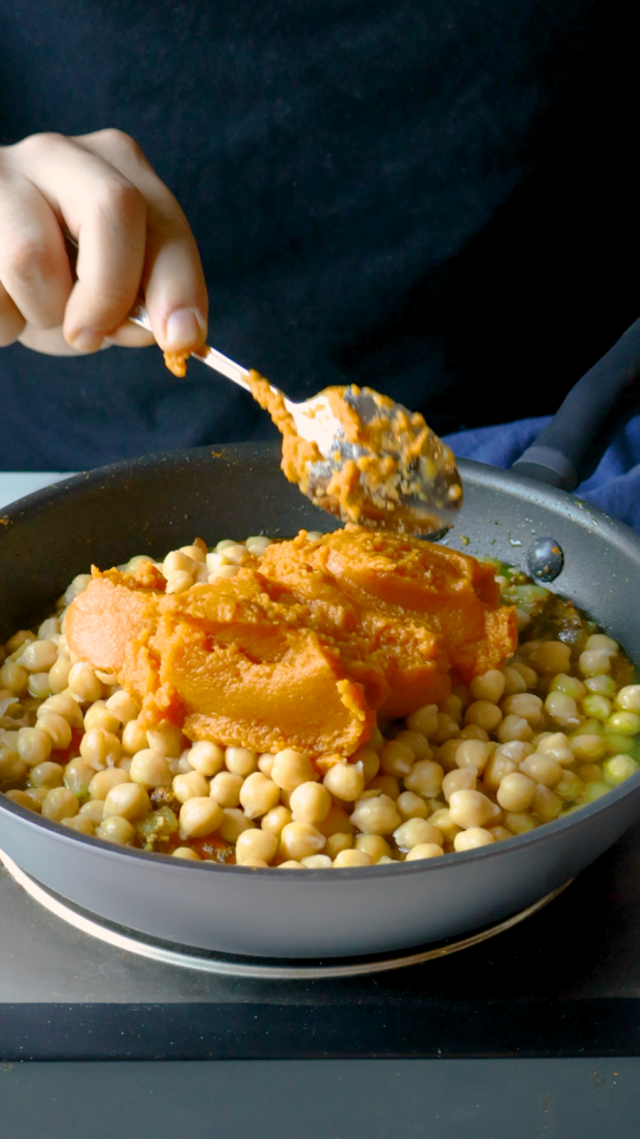 Next, add in chickpeas, coconut milk, pumpkin purée, and water. 